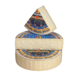 Forma di formaggio Piave Mezzano DOP a pasta dura, di colore giallo paglierino, con crosta chiara. Venduto da Orobica Food.